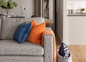 Thumbnail 3 of 10 - a living room with a couch and pillows on it
