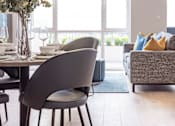 Thumbnail 2 of 15 - a dining room with a table and chairs and a large window