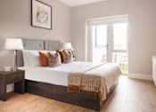 Thumbnail 6 of 15 - a bedroom with a large bed and a window