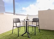 Thumbnail 8 of 15 - a terrace with a table and chairs on a grass