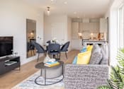 Thumbnail 11 of 23 - a living room with a couch and a table