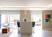 Thumbnail 21 of 23 - a dining room with a table and chairs and a large window