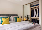 Thumbnail 6 of 23 - a bedroom with a large bed and a closet