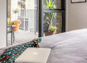 Thumbnail 3 of 23 - a bed with a laptop on top of it