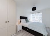 Thumbnail 9 of 16 - a bedroom with a bed and a closet