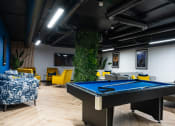 Thumbnail 6 of 8 - a game room with a pool table and a tv