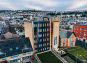 Thumbnail 2 of 8 - an aerial view of a building with a city in the background