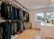 Thumbnail 7 of 7 - a closet with a window and a rack of clothes