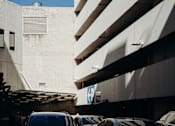 Thumbnail 14 of 14 - a parking lot full of cars in front of a building