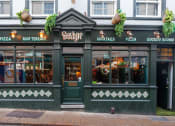 Thumbnail 9 of 12 - the exterior of a restaurant with a green facade