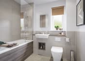 Thumbnail 3 of 12 - a bathroom with a toilet sink and bathtub in a 555 waverly unit