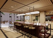 Thumbnail 5 of 37 - A modern kitchen with a bar area and a dining table.