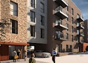 Thumbnail 11 of 23 - A modern apartment complex with people walking around the courtyard.