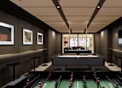 Thumbnail 13 of 37 - A billiards room with a pool table and a television.