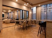 Thumbnail 27 of 29 - Modern dining set features beige upholstered chairs and a long dark wood table at Lighthaus Liverpool Apartments, Liverpool