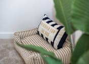 Thumbnail 29 of 37 - A striped pillow with a clapperboard on it that says "PRESERVED FOR THE 2006".