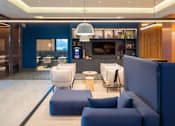 Thumbnail 6 of 32 - a living room with blue chairs and a white rug at The Keel Apartments, Liverpool