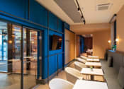 Thumbnail 7 of 32 - a restaurant with tables and chairs and blue walls at The Keel Apartments, Liverpool, L3 4GE