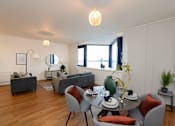 Thumbnail 12 of 32 - a living room with white walls and a table and chairs at The Keel Apartments, Liverpool, L3 4GE