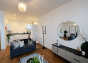 Thumbnail 13 of 32 - a living room with a couch and a mirror at The Keel Apartments, Liverpool, L3 4GE