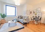 Thumbnail 14 of 32 - a living room with a couch and a dining room at The Keel Apartments, Liverpool