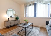 Thumbnail 17 of 32 - a living room with a couch and a table and a mirror at The Keel Apartments, Liverpool, L3 4GE