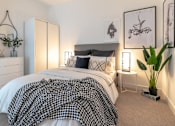 Thumbnail 20 of 32 - a bedroom with a white bed and a black and white blanket at The Keel Apartments, Liverpool, L3 4GE