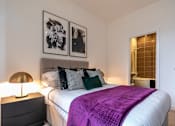 Thumbnail 26 of 32 - a bedroom with a large bed and a purple blanket at The Keel Apartments, Liverpool