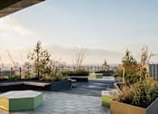 Thumbnail 4 of 30 - the roof terrace at dusk with benches and plants at Vox Apartments, Manchester, M15 4YD