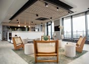 Thumbnail 6 of 30 - a large lobby with chairs and a table and a large window at Vox Apartments, Manchester, M15 4YD