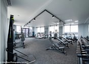 Thumbnail 8 of 30 - spacious gym with cardio equipment and views of the city at Vox Apartments, Manchester, M15 4YD