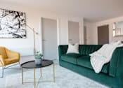 Thumbnail 11 of 30 - a living room with a green couch at Vox Apartments, Manchester