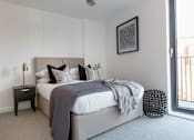 Thumbnail 18 of 30 - a bedroom with a bed and a window at Vox Apartments, Manchester