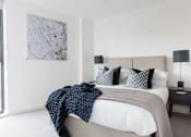Thumbnail 20 of 30 - a bedroom with a bed and a large window at Vox Apartments, Manchester