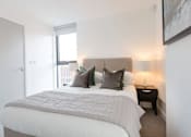 Thumbnail 23 of 30 - a bedroom with a bed and a window at Vox Apartments, Manchester, M15 4YD