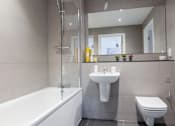 Thumbnail 24 of 30 - a bathroom with a sink toilet and a bath tub at Vox Apartments, Manchester