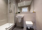 Thumbnail 25 of 30 - a bathroom with a toilet sink and shower at Vox Apartments, Manchester