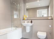Thumbnail 27 of 30 - a bathroom with a sink toilet and a bath tub at Vox Apartments, Manchester, M15 4YD