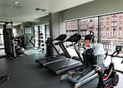 Thumbnail 24 of 24 - A gym with treadmills, exercise bikes, and other equipment.at Slate Yard Apartments, Salford