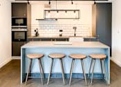 Thumbnail 20 of 24 - A kitchen with a bar stool in front of the counter.at Slate Yard Apartments, Salford, M3 5EX