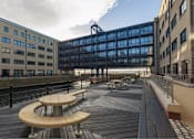 Thumbnail 3 of 32 - a large deck with benches and a building in the background at The Keel Apartments, Liverpool