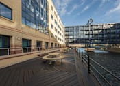 Thumbnail 30 of 32 - a boardwalk next to a river between two buildings at The Keel Apartments, Liverpool