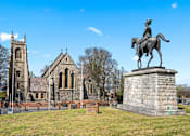 Thumbnail 15 of 15 - A statue of a man on a horse stands in front of a church.at The Quarters Apartments, Dock Road