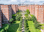 Thumbnail 1 of 24 - A view of a courtyard surrounded by red brick buildings.