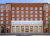 Thumbnail 2 of 24 - A large red brick building with the words "Dolphin Square" on the front.