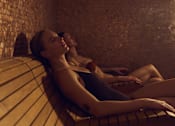 Thumbnail 23 of 24 - Two women relaxing in a sauna.