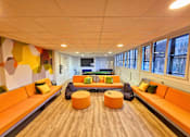 Thumbnail 1 of 11 - a living room with couches and chairs and a large window