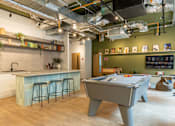 Thumbnail 4 of 27 - a game room with a pool table and a bar
