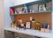 Thumbnail 9 of 27 - a white desk with a shelf and some items on it