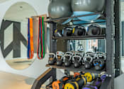 Thumbnail 25 of 27 - a rack of weights and other equipment in a gym